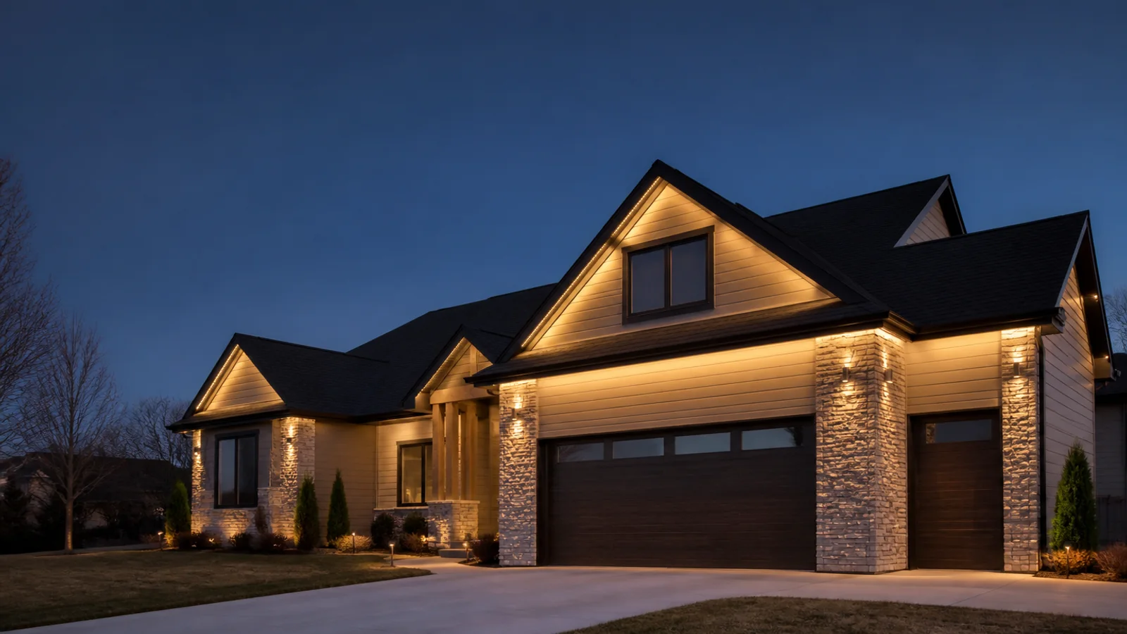 Discreet permanent warm white lighting integrated beneath the roofline of a modern Wichita area home at twilight